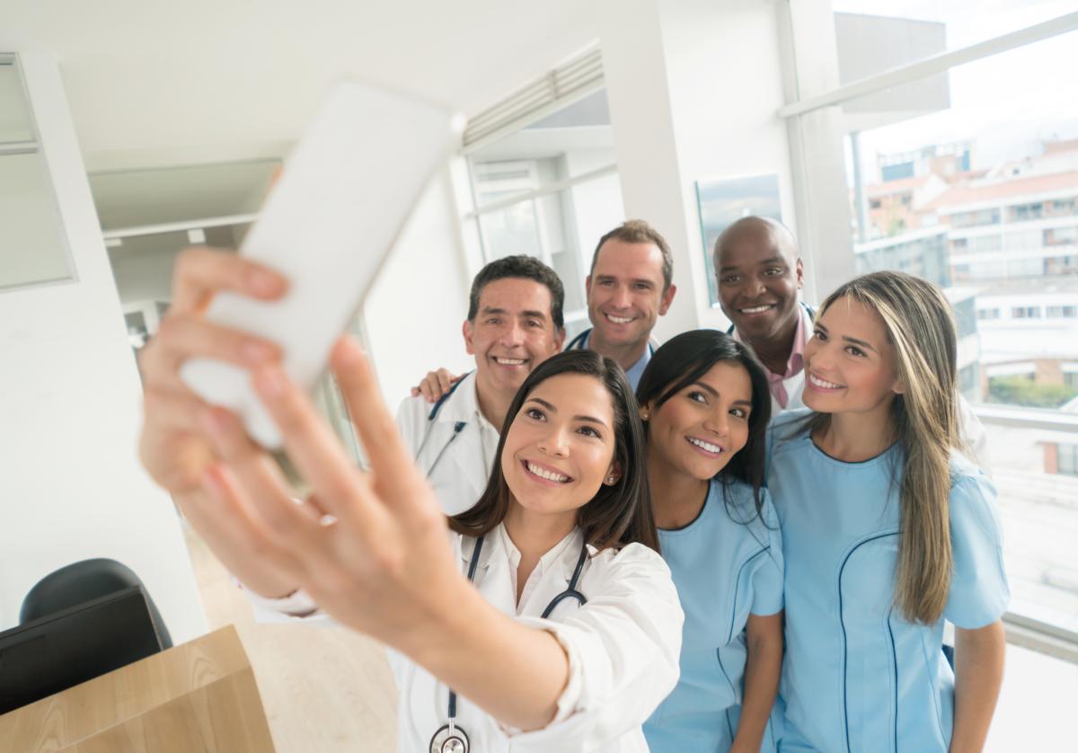 A diverse group of medical students taking a selfie together.